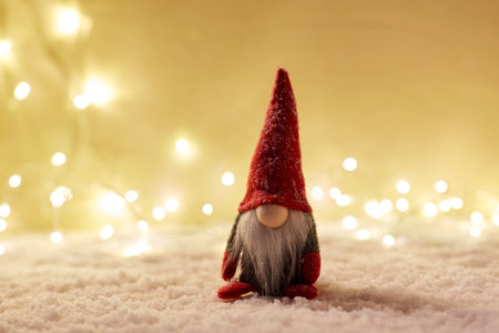 close up of christmas gnome toy on artificial snowの写真素材