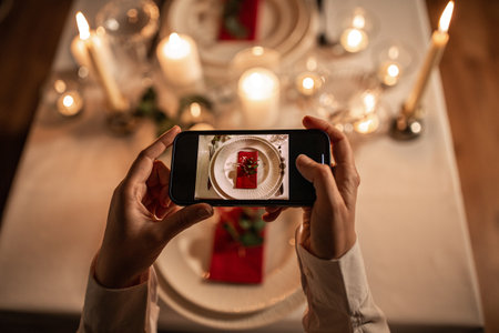 hands with smartphone photographing table servingの写真素材