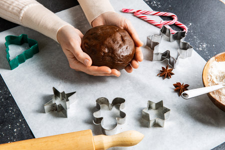 close up of hands holding gingerbread doughの写真素材