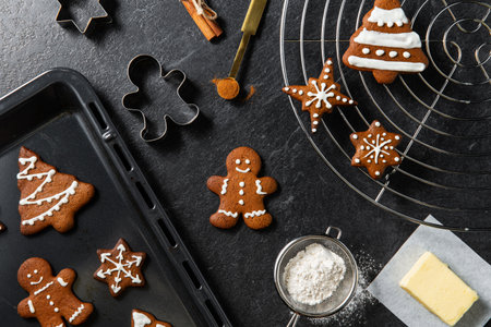 close up of gingerbread and molds on black tableの写真素材