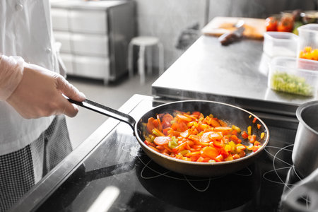 close up of chef cooking food at restaurantの写真素材