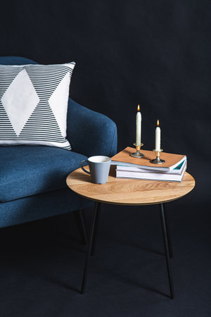 close up of chair and coffee table over black wallの写真素材