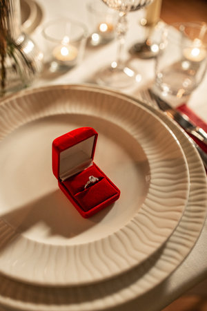 engagement ring in red box on served tableの写真素材