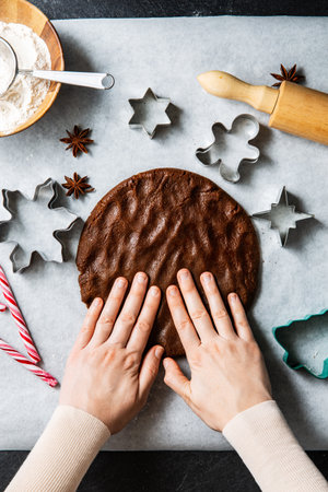 close up of hands spreading gingerbread doughの写真素材