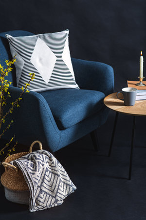 blue chair and blanket in basket over black wallの写真素材