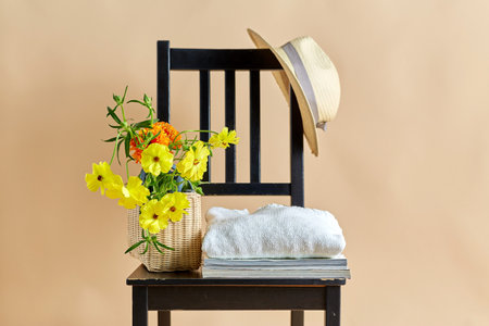 flowers in basket, clothes and hat on old chairの写真素材