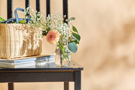 flowers in basket on chair over beige backgroundの写真素材