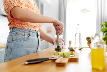 woman making cocktail drinks at home kitchenの写真素材