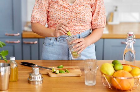 woman making cocktail drinks at home kitchenの写真素材