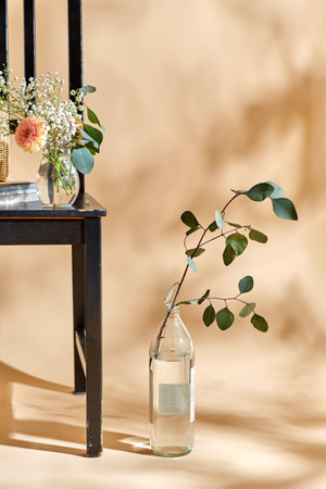 flowers in vase on chair over beige backgroundの写真素材