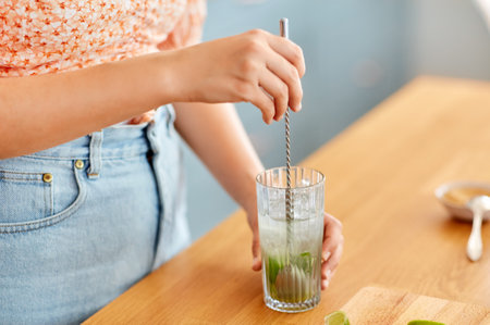woman making cocktail drinks at home kitchenの写真素材