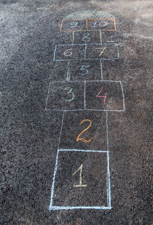 hopscotch chalk drawing on asphalt pavement
