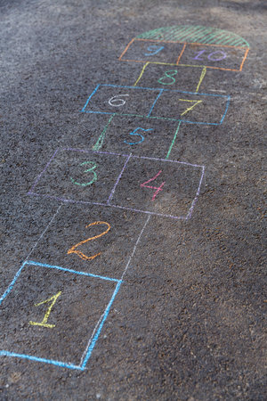 hopscotch chalk drawing on asphalt pavementの写真素材