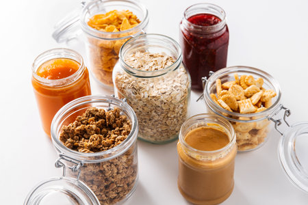 close up of jars with oat, corn flakes and granolaの写真素材