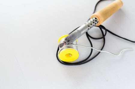 solder wire and soldering iron with wooden handle on gray background.の写真素材