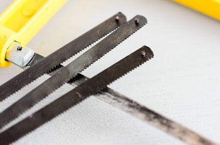 Small hand saw with spare blades for wood and metall.