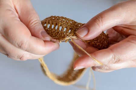 Womans hands with crochet hook and yarn. Handmade hobby concept