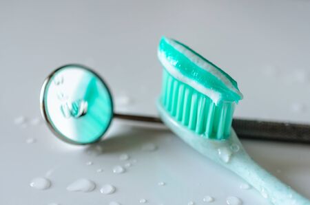 Toothbrush with toothpaste and dental mirror. Oral hygiene health conceptの写真素材