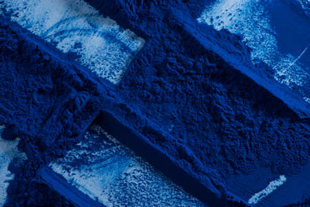 Blue spirulina powder texture on white background. Phycocyanin extract. Natural superfood, vegan, healthy dietary supplement.の写真素材