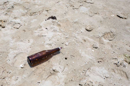 bottle on the dirty beachの写真素材