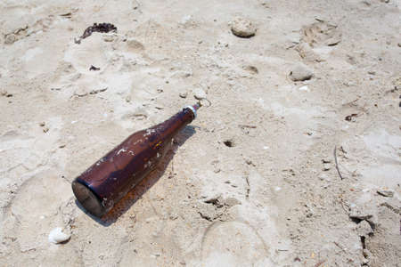 bottle on the dirty beachの写真素材