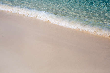 Wave of the sea on the sand beachの写真素材