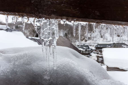 Icicles on the roof of a houseの写真素材