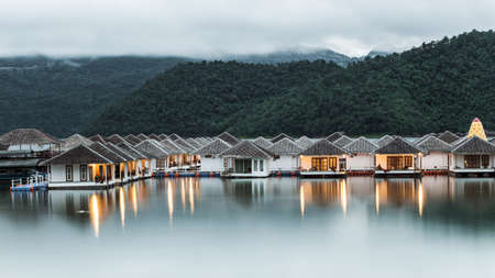 Floating  houses on Srinakarin dam at twilightの写真素材