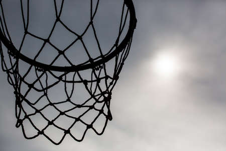 silhouette of basketball hoop against the soft  sunlightの写真素材