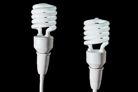 fluorescent light bulb isolated on a black bakgroundの写真素材