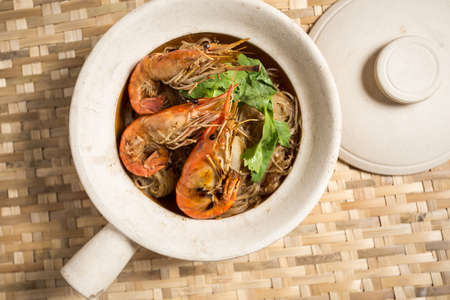 Casseroled prawns with vermicelli in clay potの写真素材