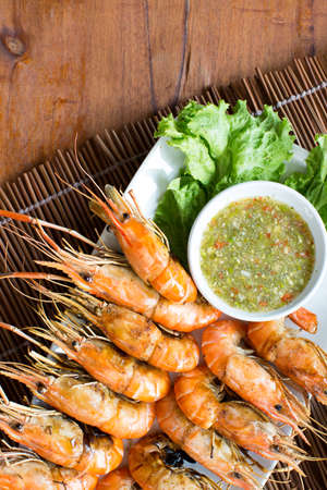 Grilled shrimps set on dish with seafood sauceの写真素材