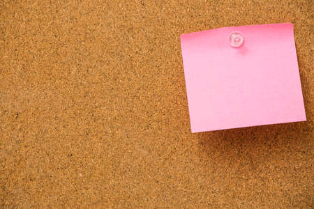pink sticky notes on cork  board