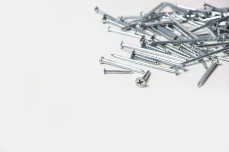 Screws and nails on white background