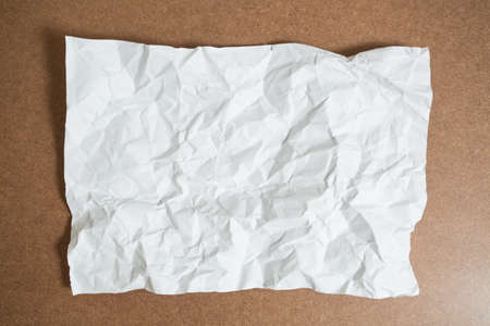 Crumpled White Paper on tableの写真素材