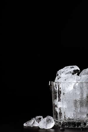 crystal bucket with ice on a dark background