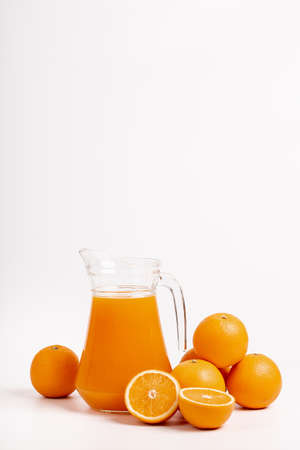 glass  jar of fresh orange juice with fresh orange on white backgroundの写真素材