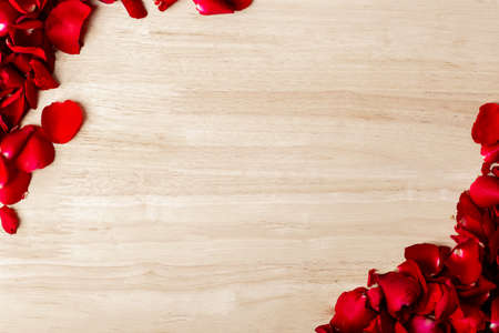red rose petals frame on wooden backgroundの写真素材