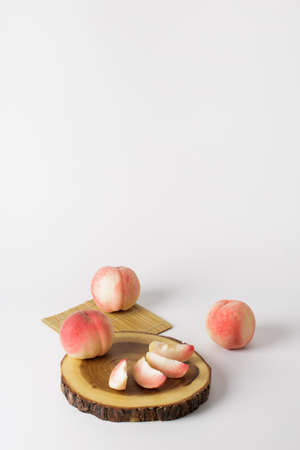 honey peach in wooden bowl on white backgroundの写真素材