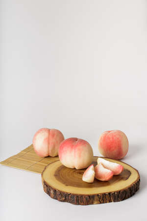 honey peach in wooden bowl on white backgroundの写真素材