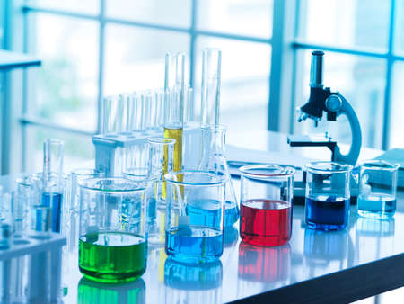 green, blue, red , and dark blue color liquid in glass beaker and yellow one in tube at the laboratory for researchers to do their work.の写真素材