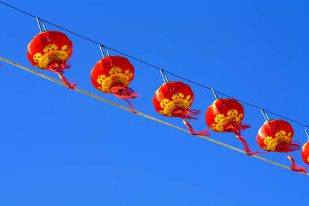 Red Chinese Paper Lanterns against a Blue Sky.