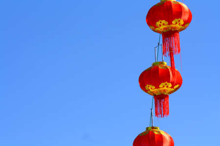 Red Chinese Paper Lanterns against a Blue Sky.の写真素材