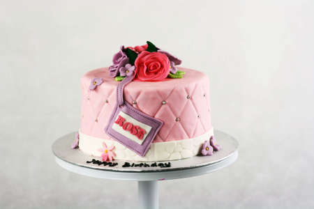 Pink fondant cake with rose fondant decorationの写真素材