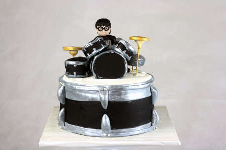 Creative fondant Drummer ispired cake with grey plain backgroundの写真素材