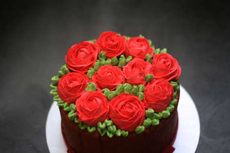 Blur buttercream cake red rose on top for backgroundの写真素材