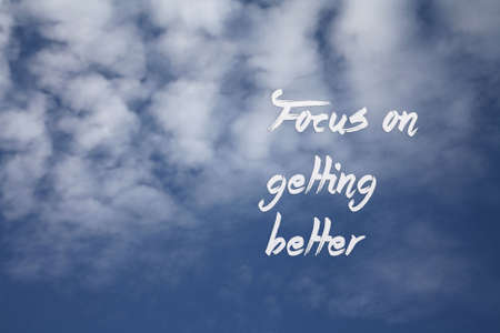 Focus on getting better - wording with blue sky and clouds backgroundの写真素材
