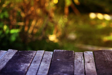 Black wooden table plank with blur nature background, copy spaceの写真素材