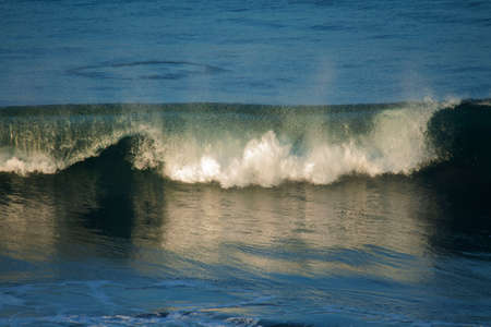 Surfing wave with blue and green waterの写真素材