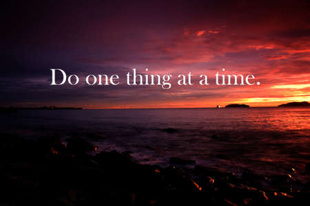 Do one thing at a time. Positve saying and motivation. Sunset background.の写真素材
